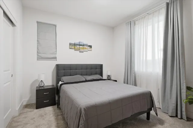 a bedroom with a bed and a window