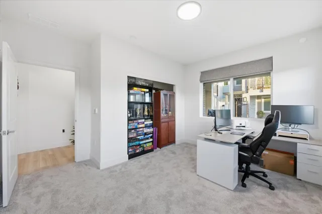 a view of a workspace with furniture and a window