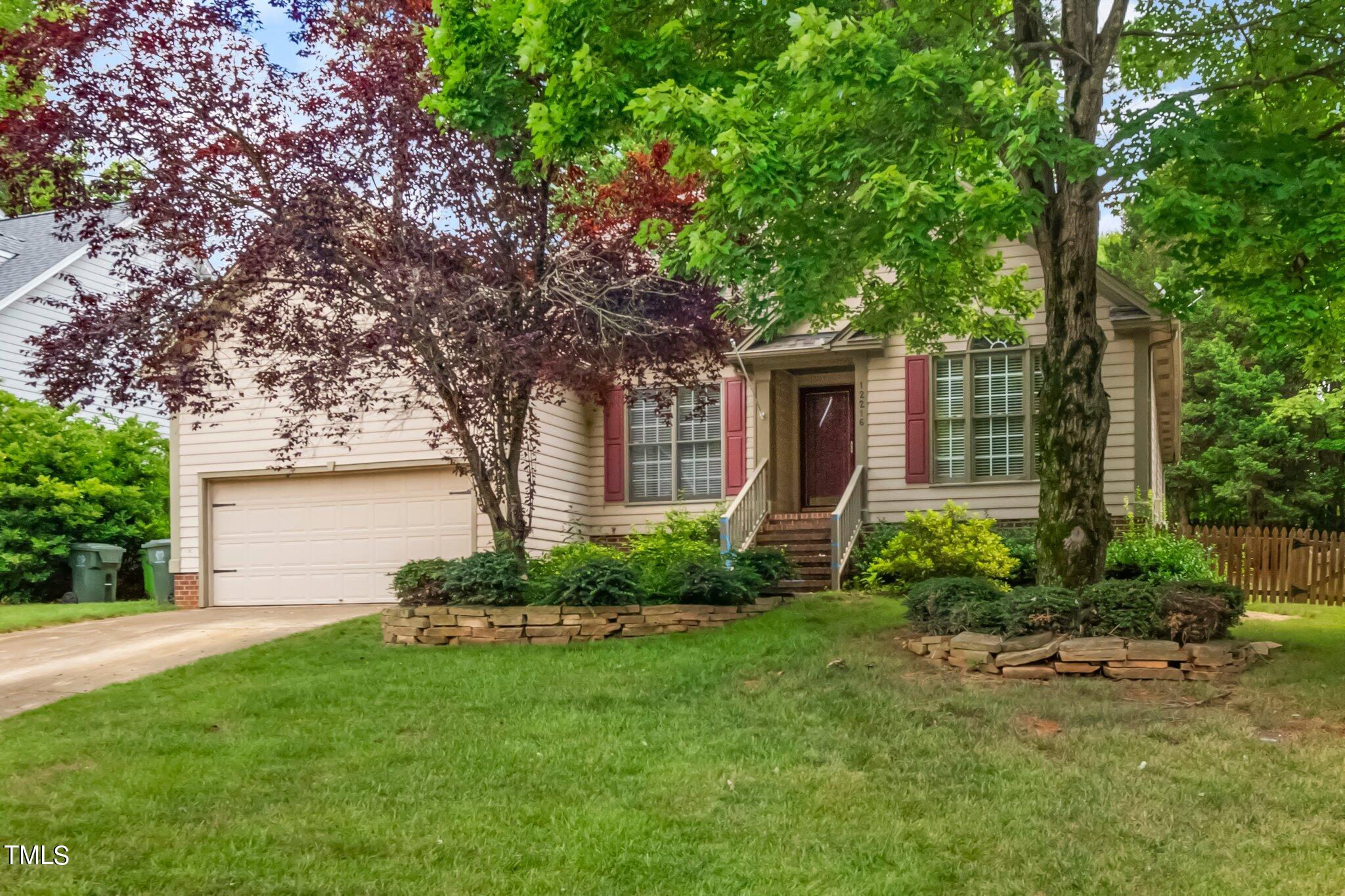 12216 Freemont Lane Raleigh, NC 27613 - Photo 1 of 23 a front view of a house with garden