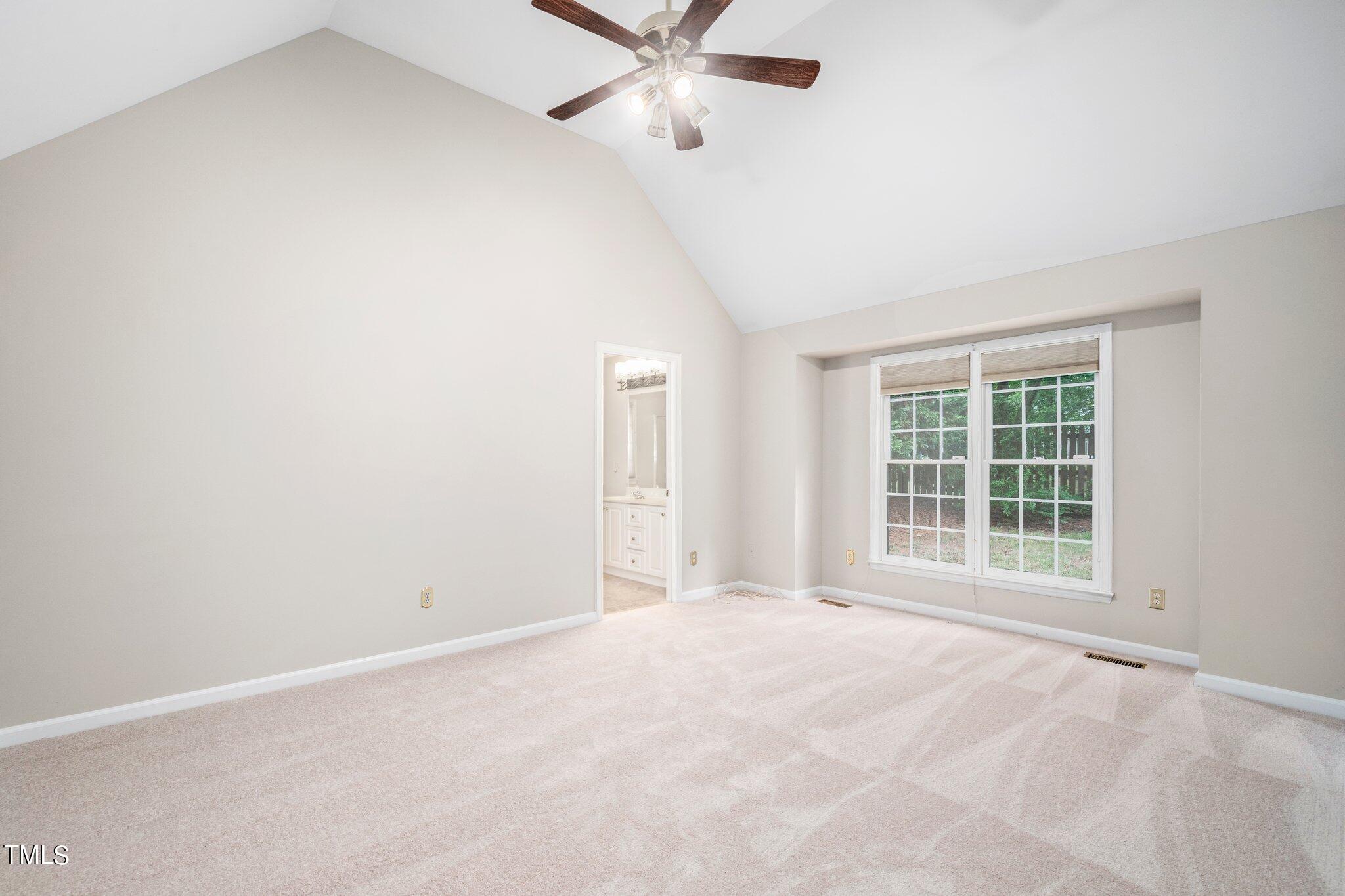 12216 Freemont Lane Raleigh, NC 27613 - Photo 15 of 23 an empty room with window and a ceiling fan
