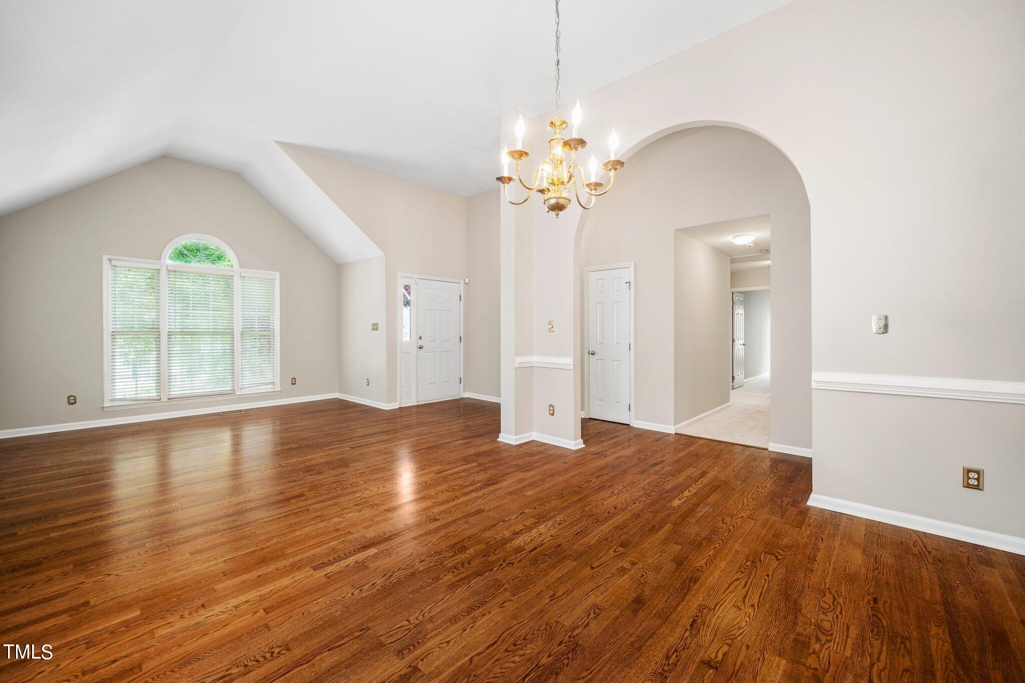 12216 Freemont Lane Raleigh, NC 27613 - Photo 2 of 23 a view of empty room with wooden floor and fan