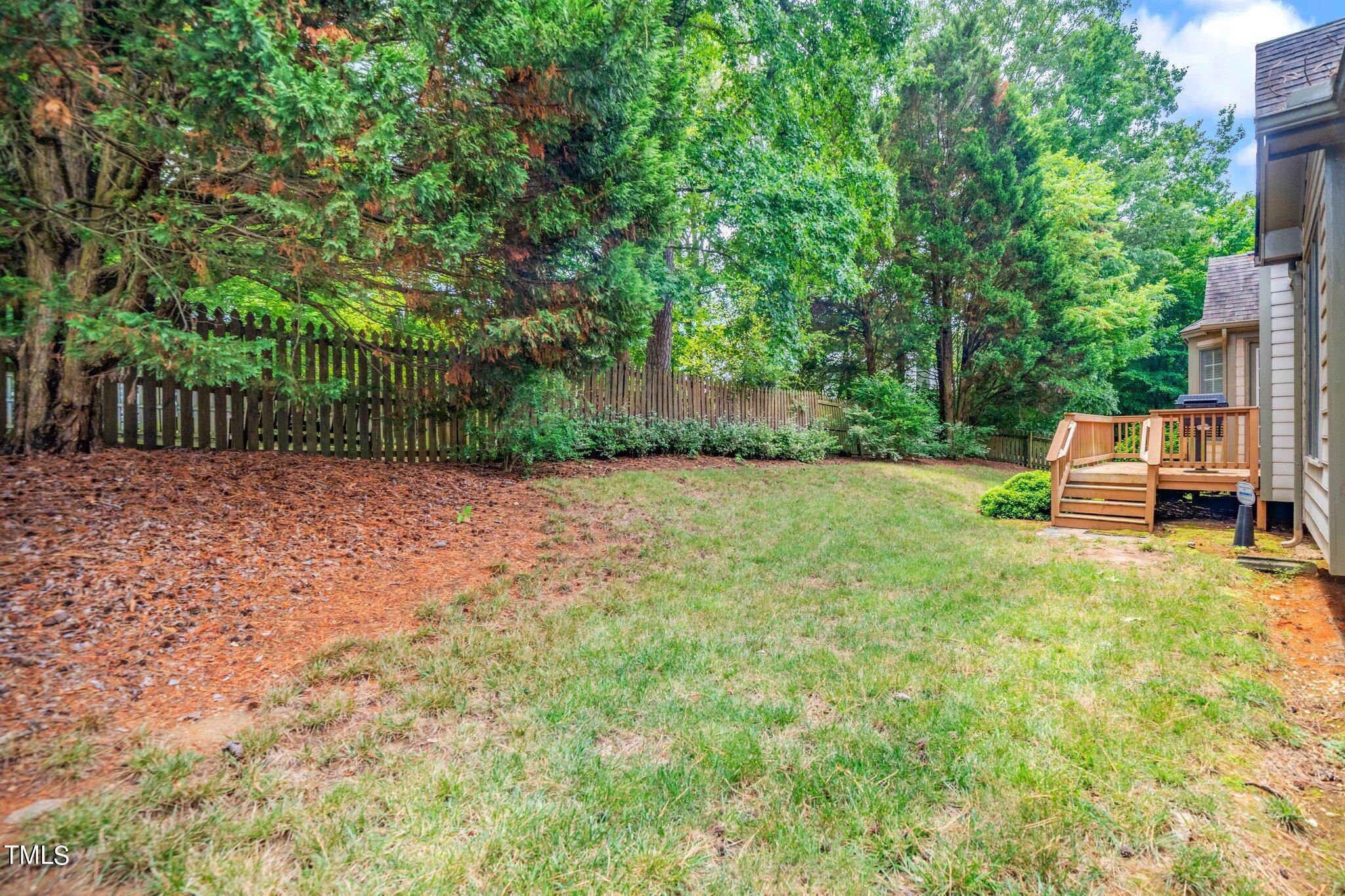 12216 Freemont Lane Raleigh, NC 27613 - Photo 21 of 23 a view of a backyard with large trees