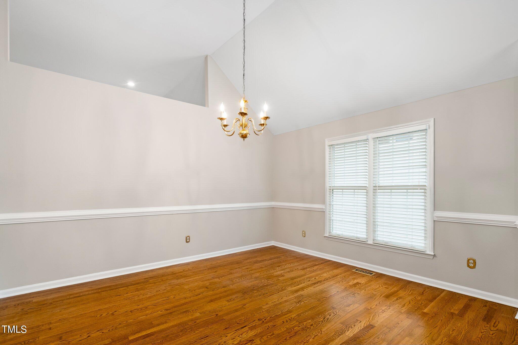 12216 Freemont Lane Raleigh, NC 27613 - Photo 3 of 23 a view of empty room with wooden floor and fan