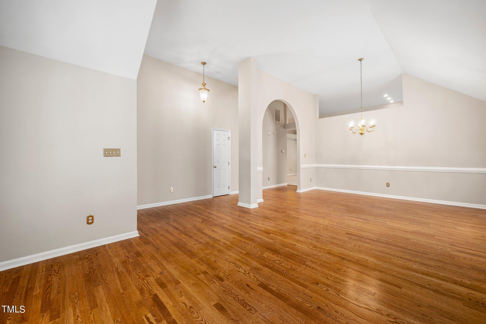 12216 Freemont Lane Raleigh, NC 27613 - Photo 5 of 23 a view of a room with wooden floor and white walls