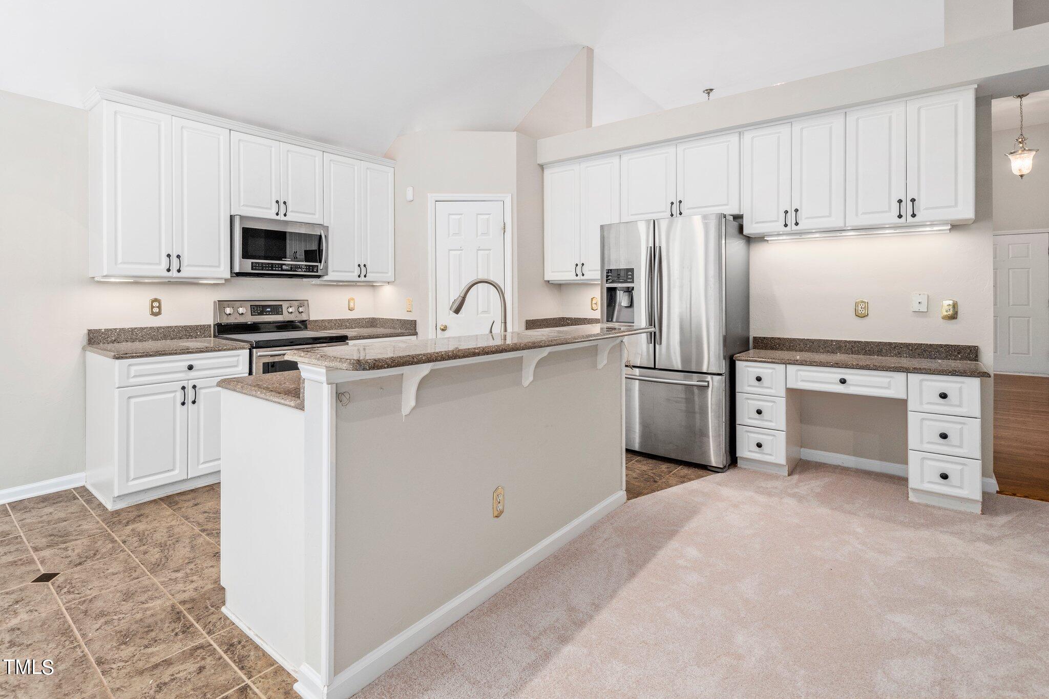 12216 Freemont Lane Raleigh, NC 27613 - Photo 6 of 23 a kitchen with cabinets stainless steel appliances and a counter space