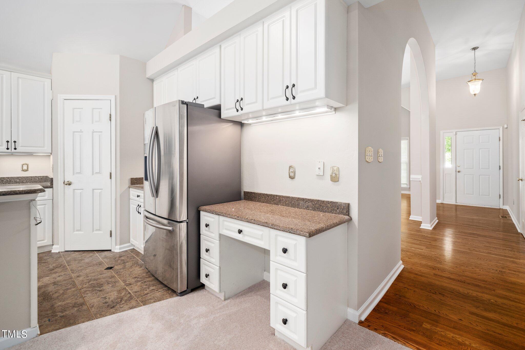 12216 Freemont Lane Raleigh, NC 27613 - Photo 9 of 23 a kitchen with stainless steel appliances granite countertop a refrigerator and a stove