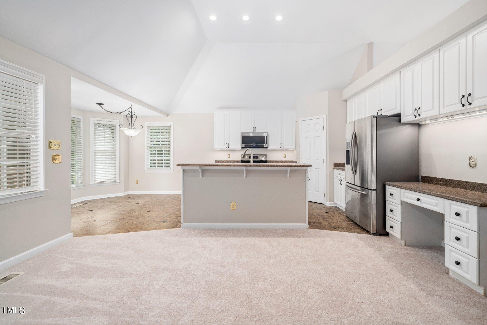 12216 Freemont Lane Raleigh, NC 27613 - Photo 10 of 23 a kitchen with stainless steel appliances granite countertop a refrigerator sink and cabinets