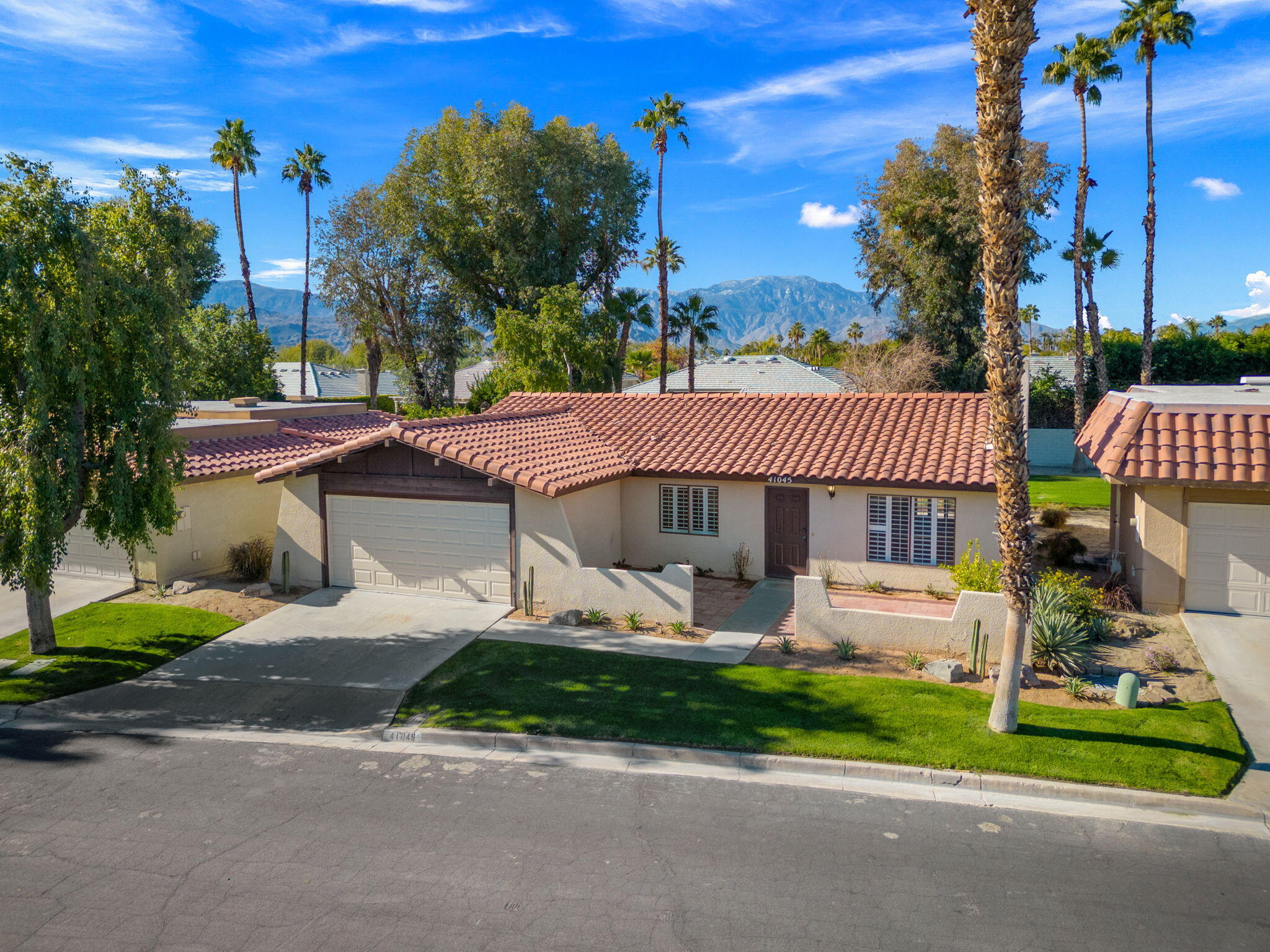 41045 Largo Palm Desert, CA 92211 - Photo 1 of 46 a front view of a house with garden