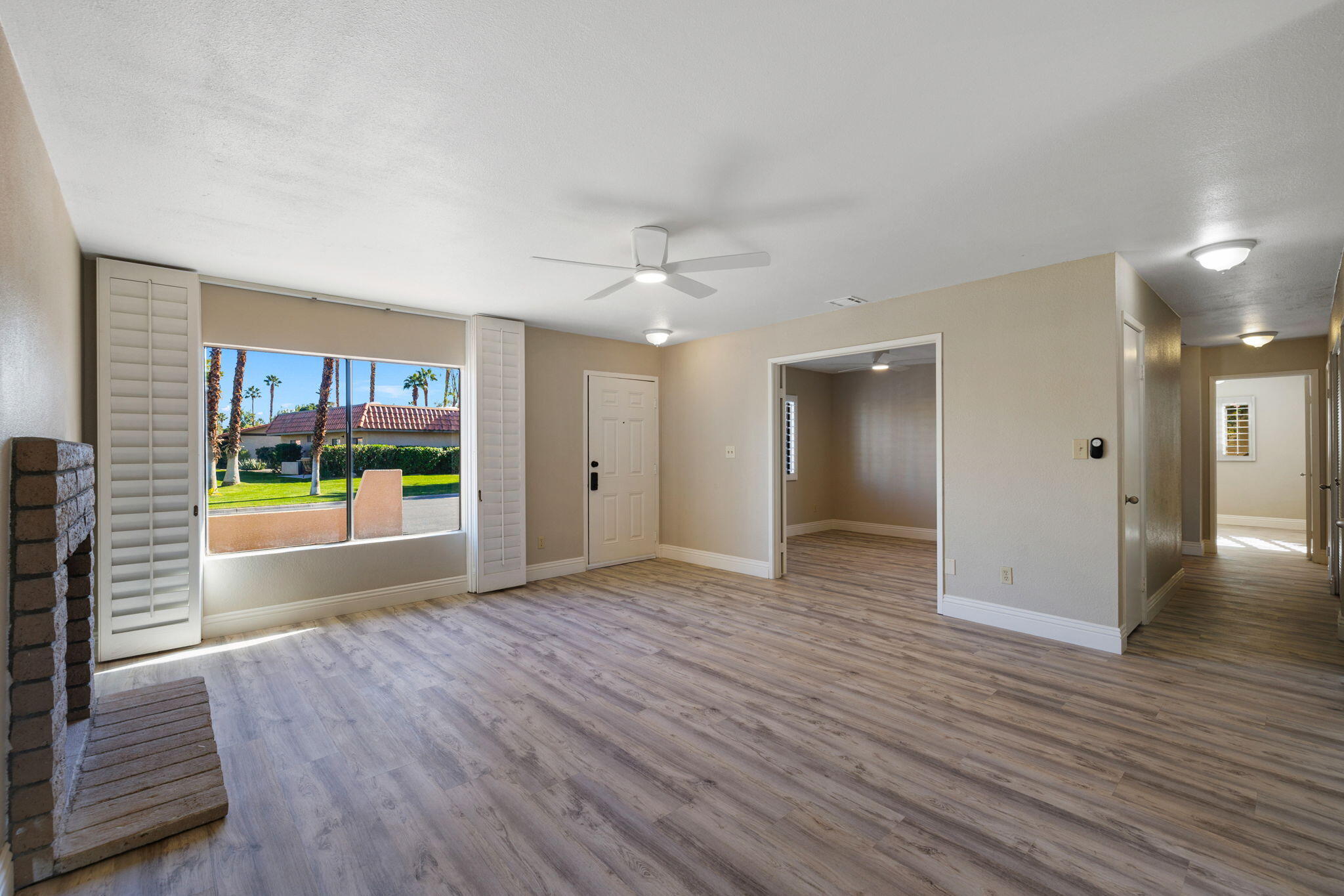41045 Largo Palm Desert, CA 92211 - Photo 13 of 46 wooden floor in an empty room with a window