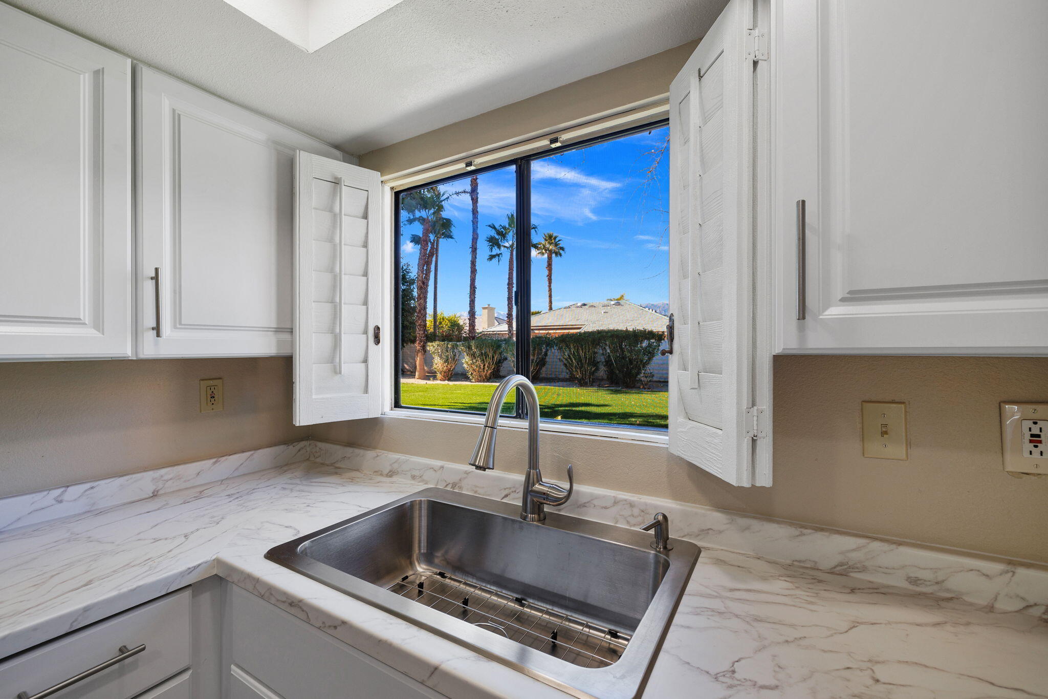 41045 Largo Palm Desert, CA 92211 - Photo 20 of 46 a kitchen with a sink and a cabinets
