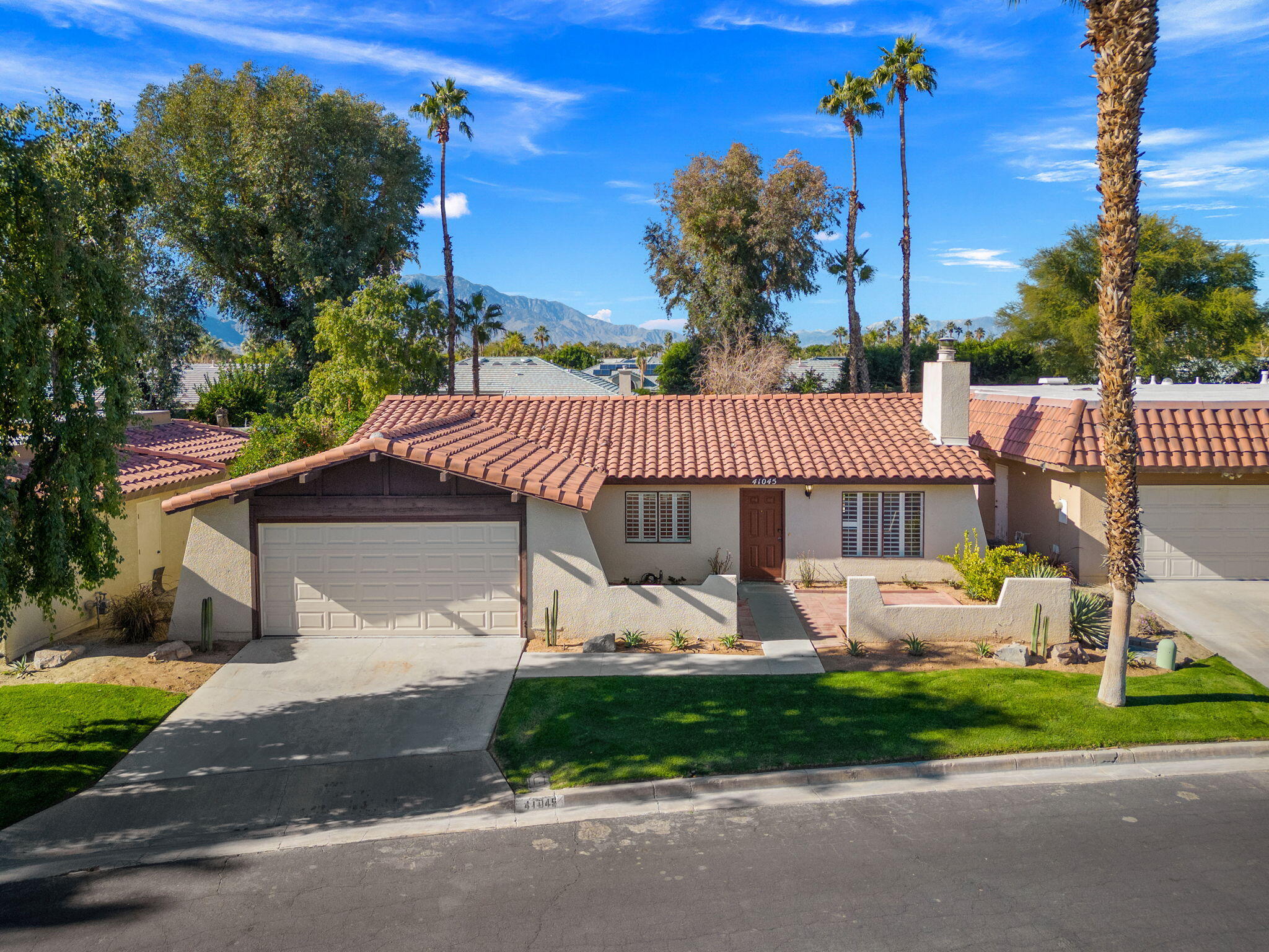 41045 Largo Palm Desert, CA 92211 - Photo 2 of 46 a front view of a house with garden