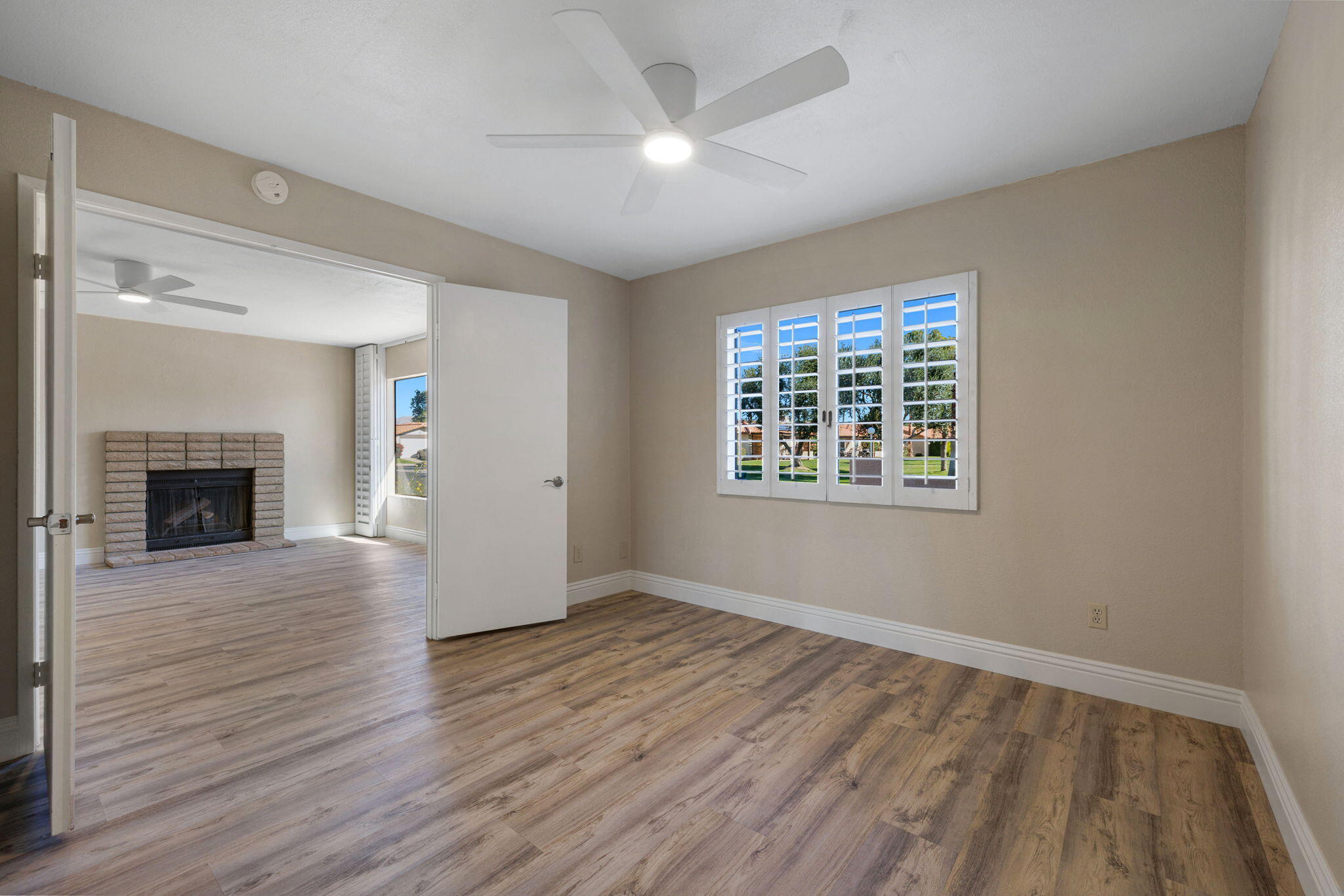 41045 Largo Palm Desert, CA 92211 - Photo 22 of 46 wooden floor in an empty room with a window