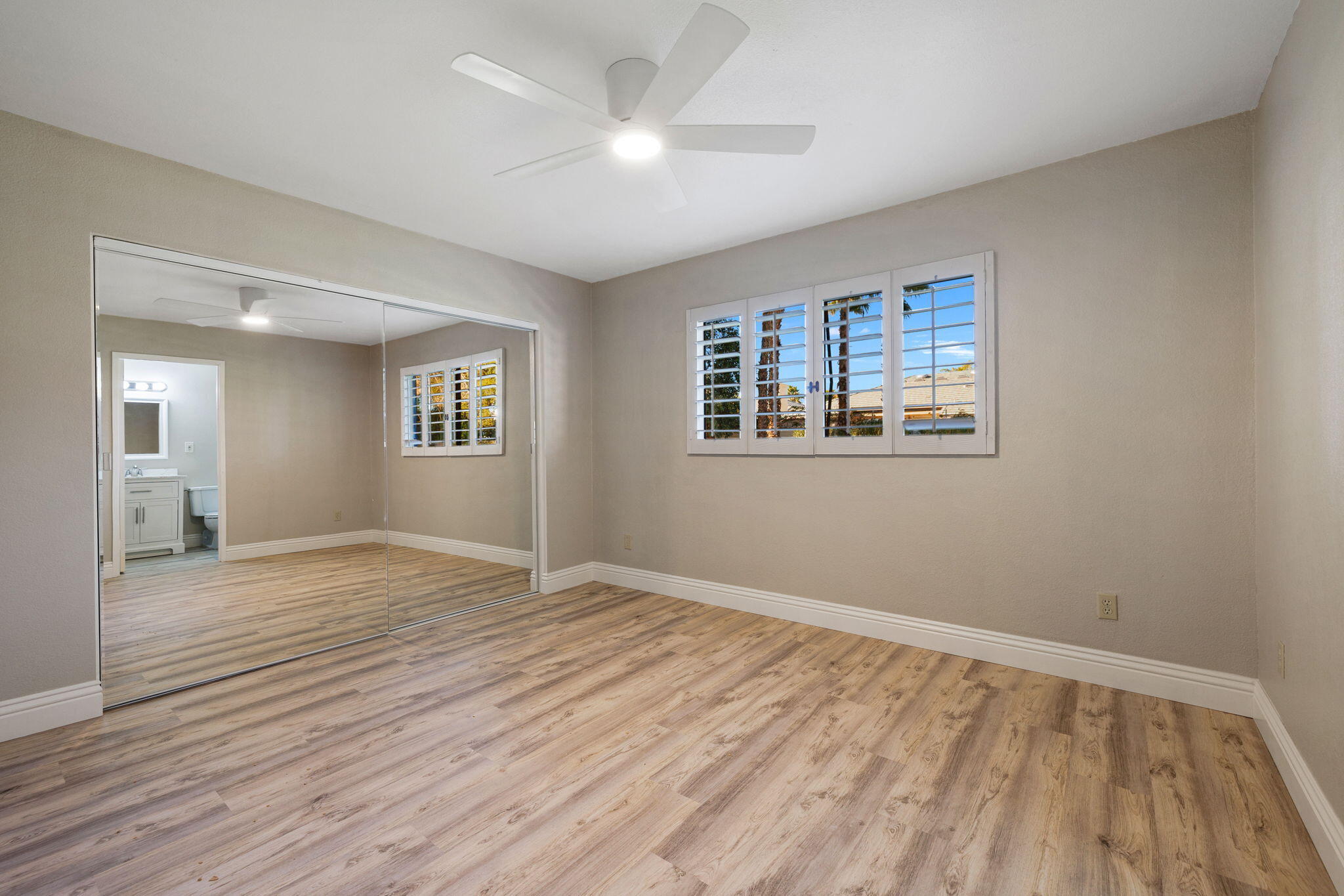 41045 Largo Palm Desert, CA 92211 - Photo 24 of 46 a view of empty room with wooden floor and fan