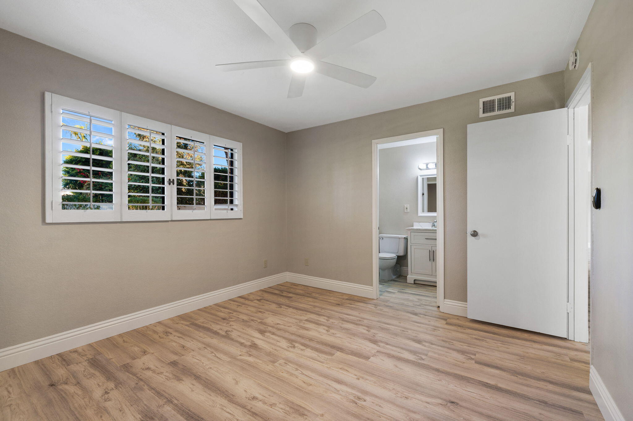 41045 Largo Palm Desert, CA 92211 - Photo 27 of 46 a view of empty room with wooden floor and fan