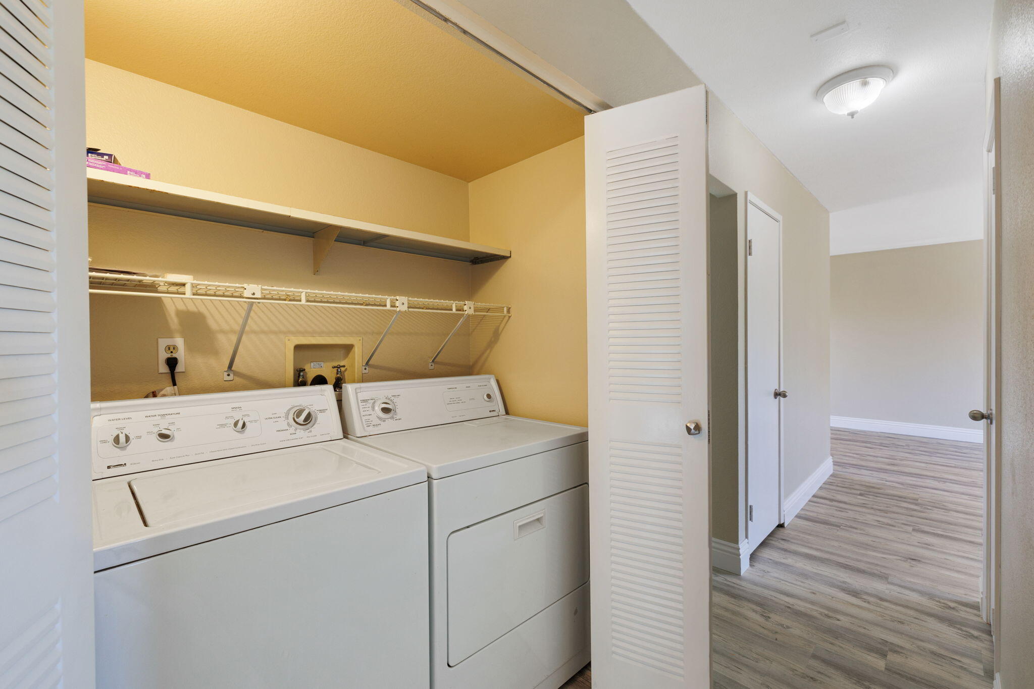 41045 Largo Palm Desert, CA 92211 - Photo 31 of 46 a view of washer and dryer with wooden cabinets