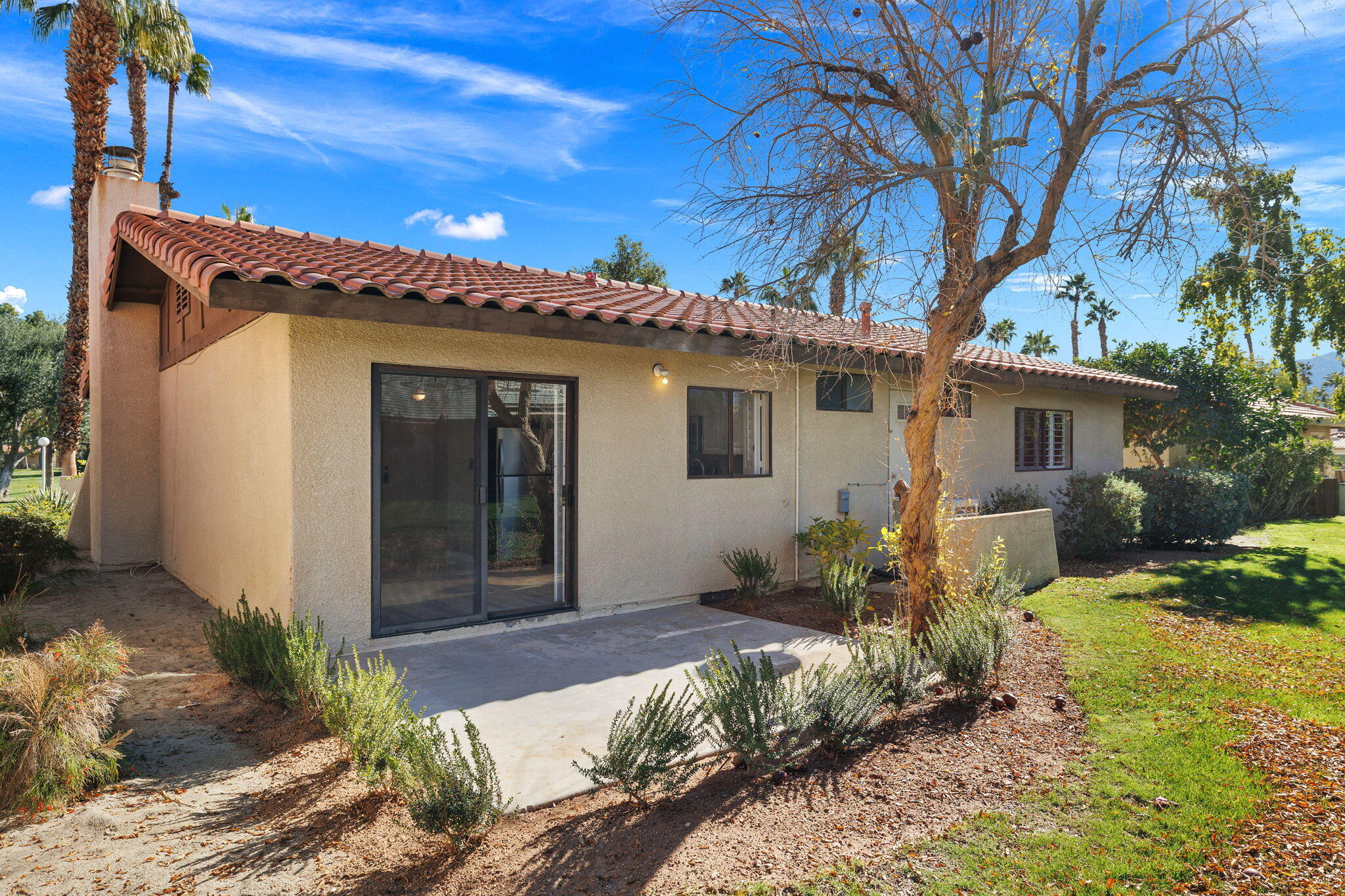 41045 Largo Palm Desert, CA 92211 - Photo 32 of 46 a front view of a house with garden