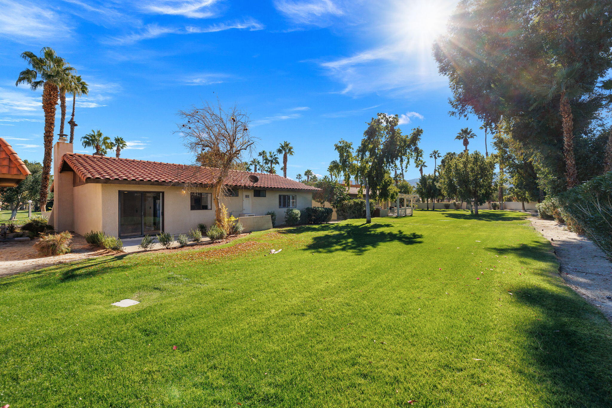 41045 Largo Palm Desert, CA 92211 - Photo 35 of 46 a front view of a house with a garden