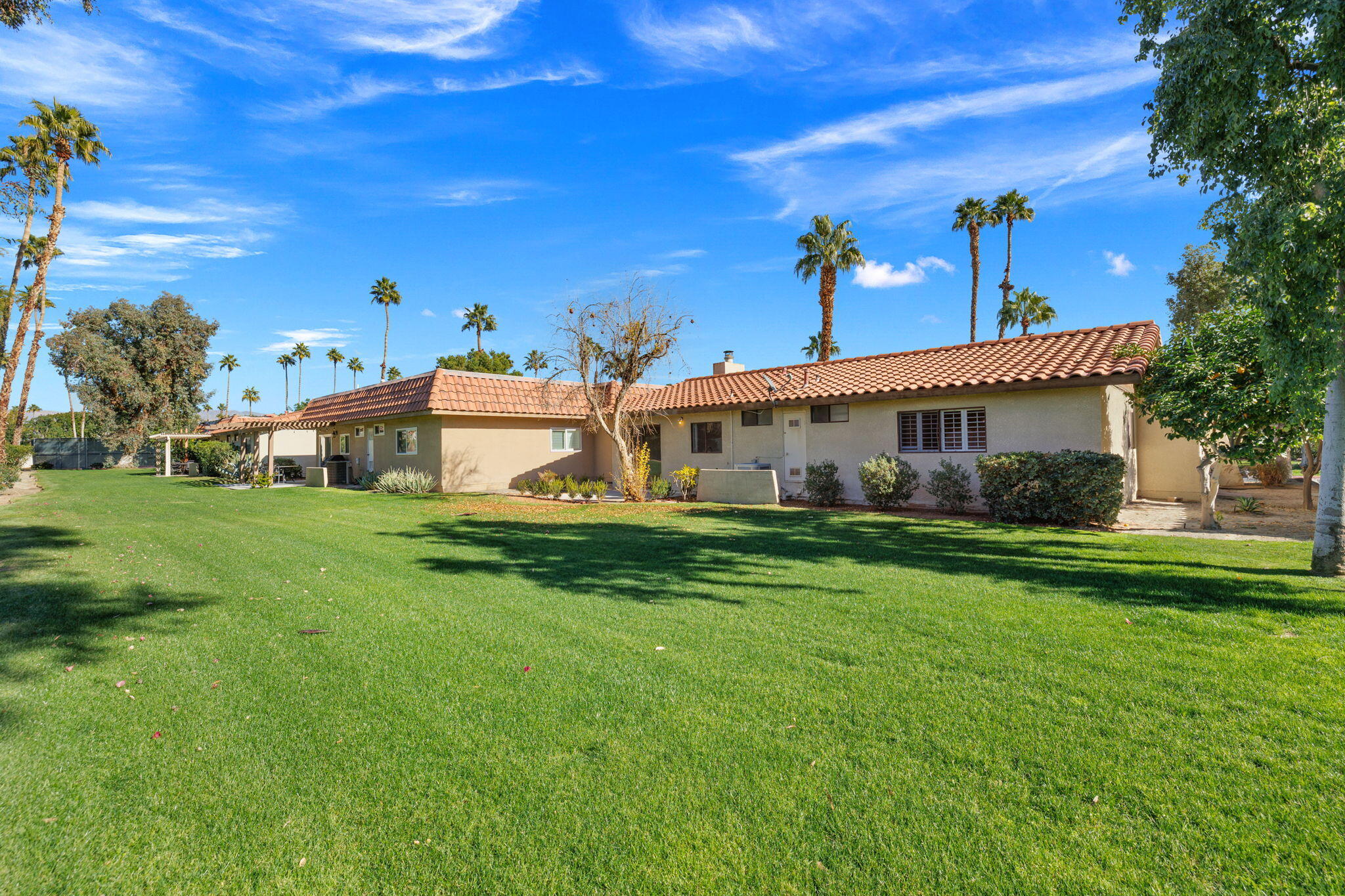 41045 Largo Palm Desert, CA 92211 - Photo 37 of 46 a front view of a house with garden