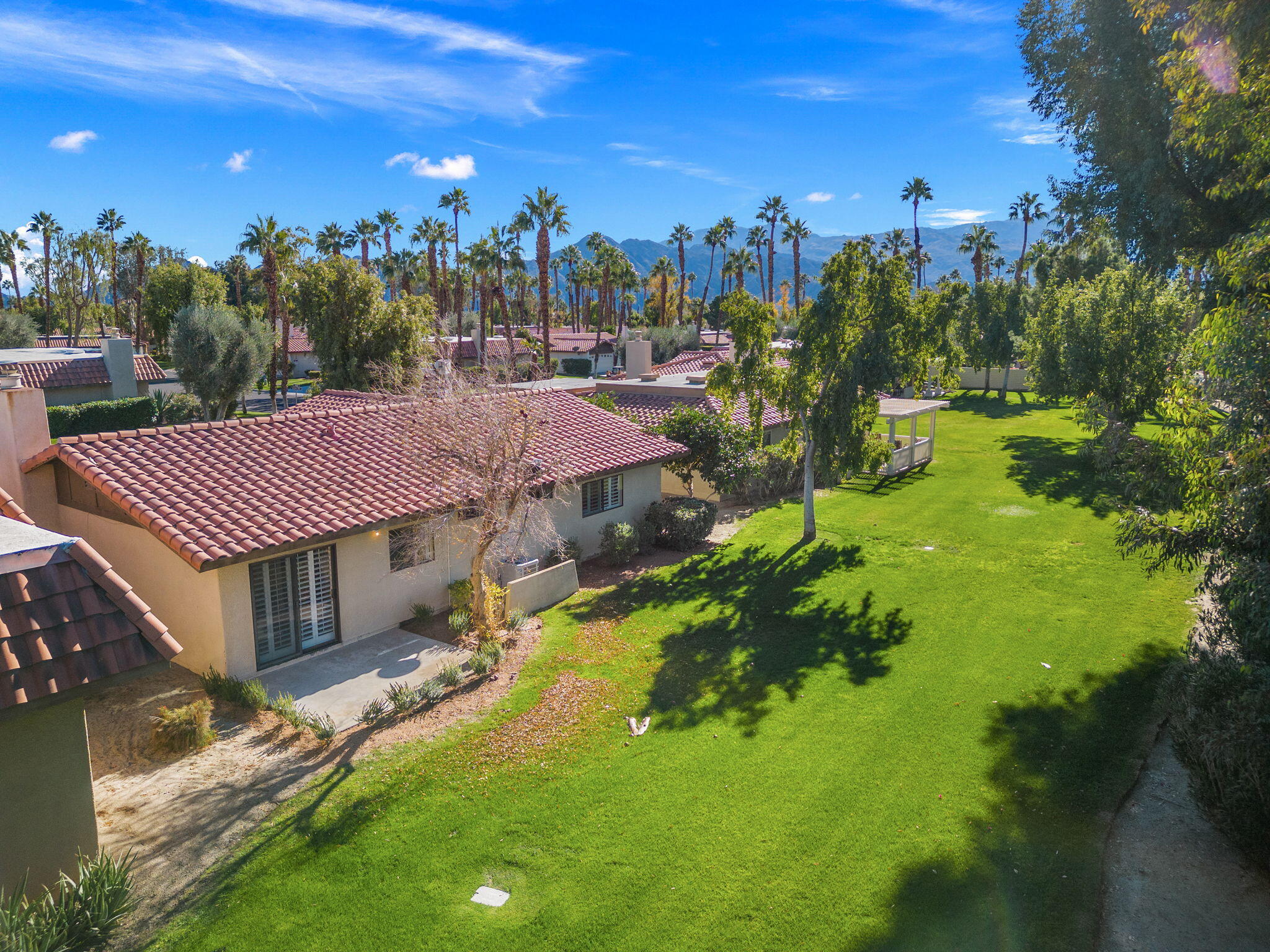 41045 Largo Palm Desert, CA 92211 - Photo 38 of 46 a view of a house with a yard