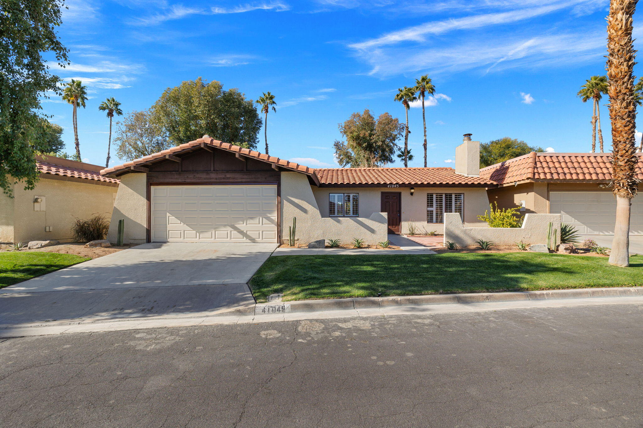 41045 Largo Palm Desert, CA 92211 - Photo 42 of 46 a front view of a house with a garden
