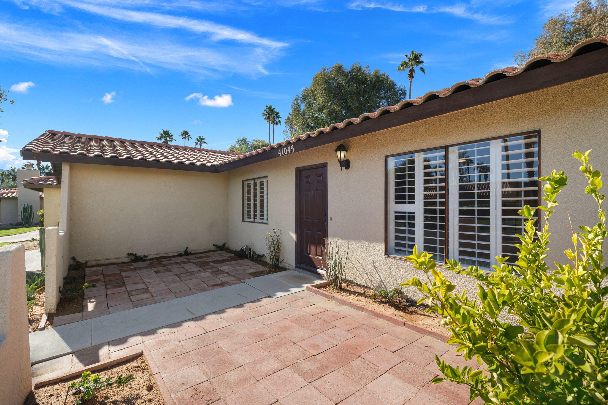 41045 Largo Palm Desert, CA 92211 - Photo 5 of 46 a view of a porch with a bench