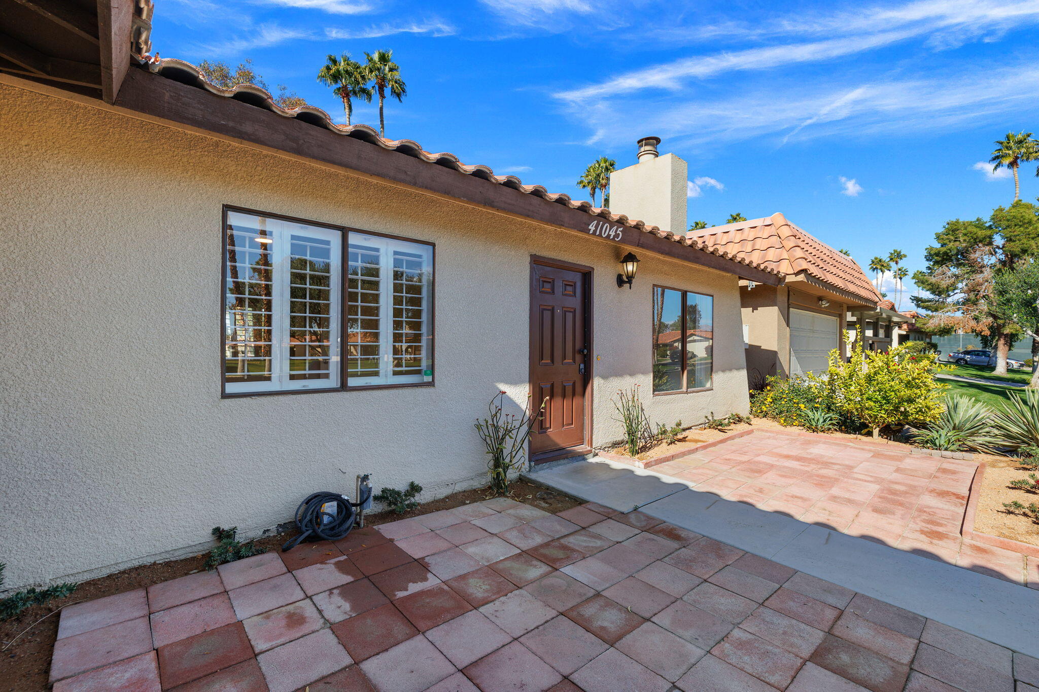 41045 Largo Palm Desert, CA 92211 - Photo 8 of 46 a front view of a house with a yard