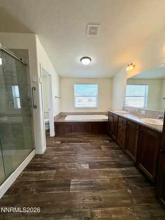 a bathroom with a granite countertop sink shower and a mirror
