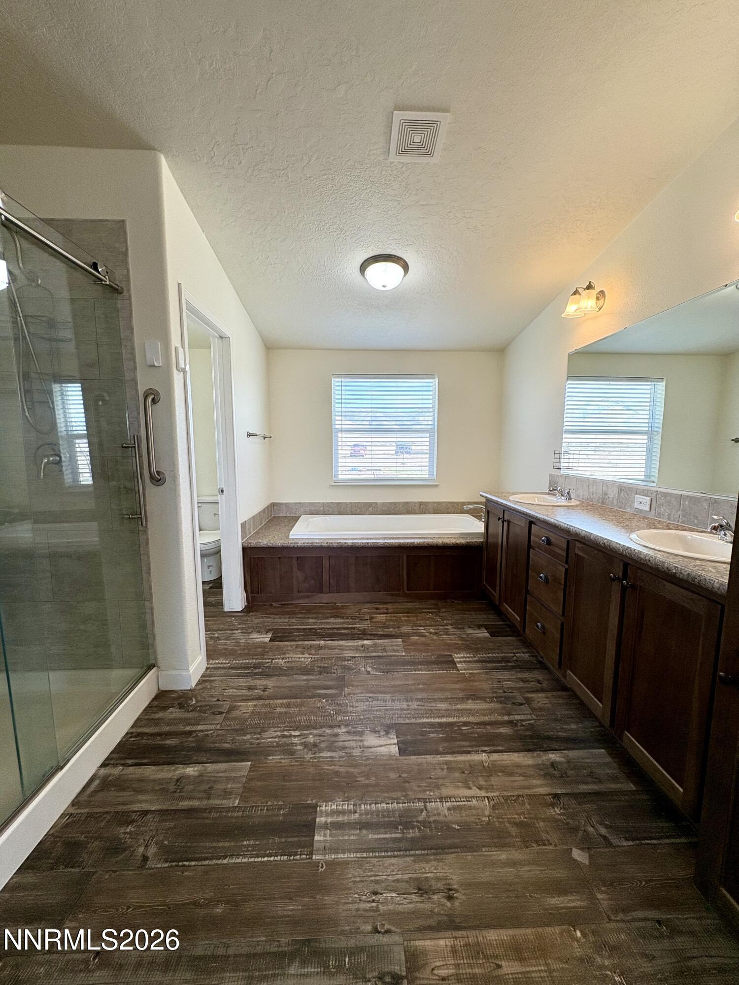 1415 Van Diest Road Winnemucca, NV 89445 - Photo 16 of 34 a view of a bathroom with a sink a window and a mirror
