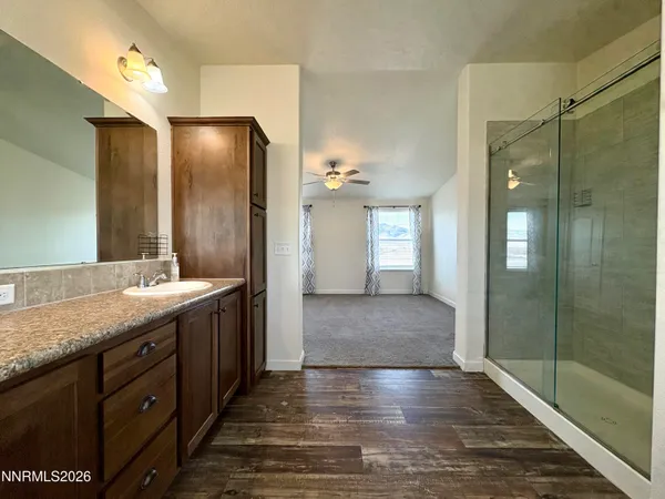 a bathroom with double vanity and a mirror