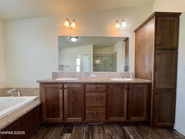 a spacious bathroom with a tub and a shower