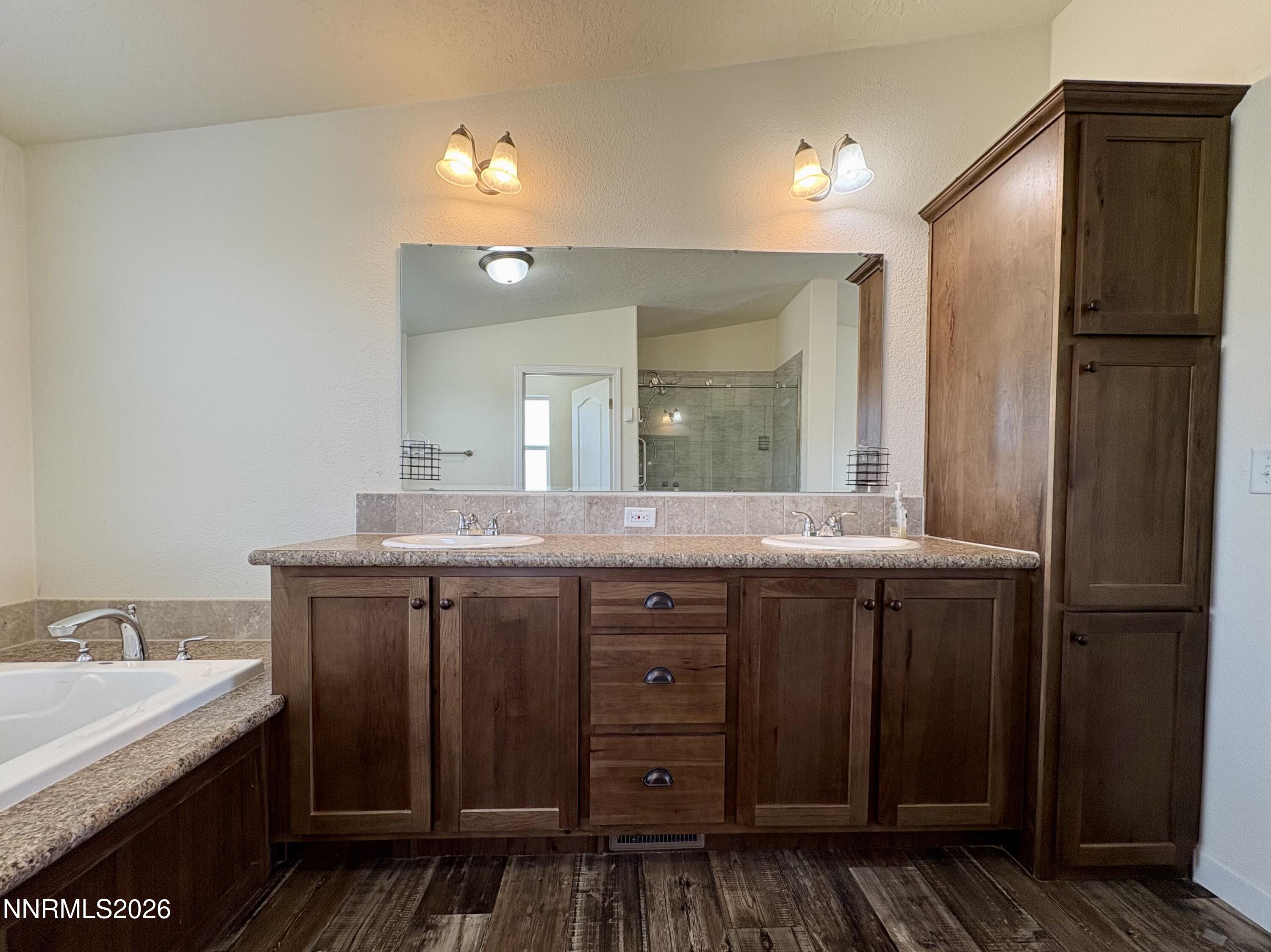 1415 Van Diest Road Winnemucca, NV 89445 - Photo 19 of 34 a spacious bathroom with a granite countertop sink a mirror and a bathtub