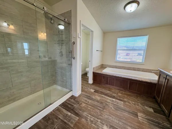 a bathroom with a double vanity sink a mirror and a bathtub