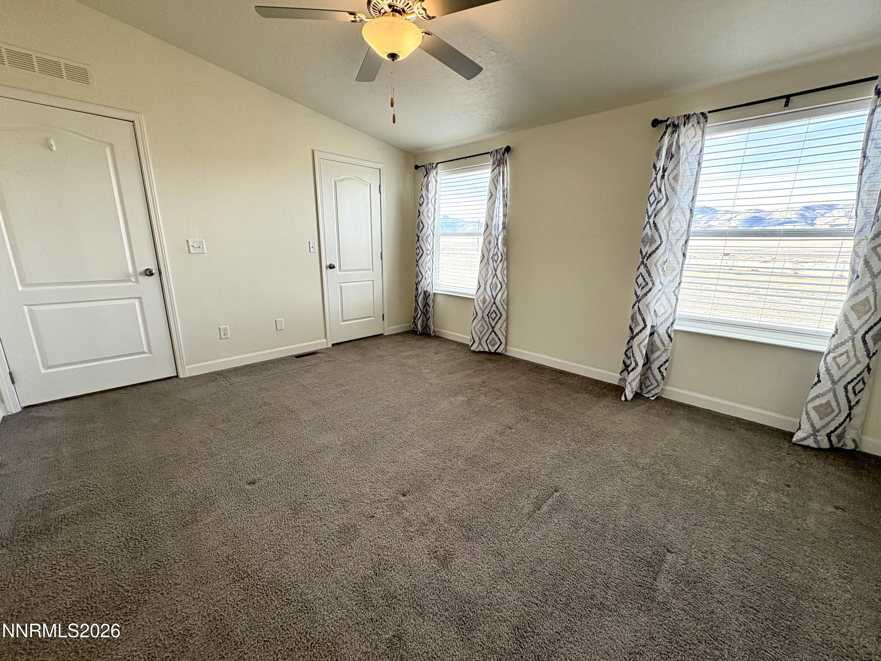 1415 Van Diest Road Winnemucca, NV 89445 - Photo 22 of 34 an empty room with a ceiling fan and window