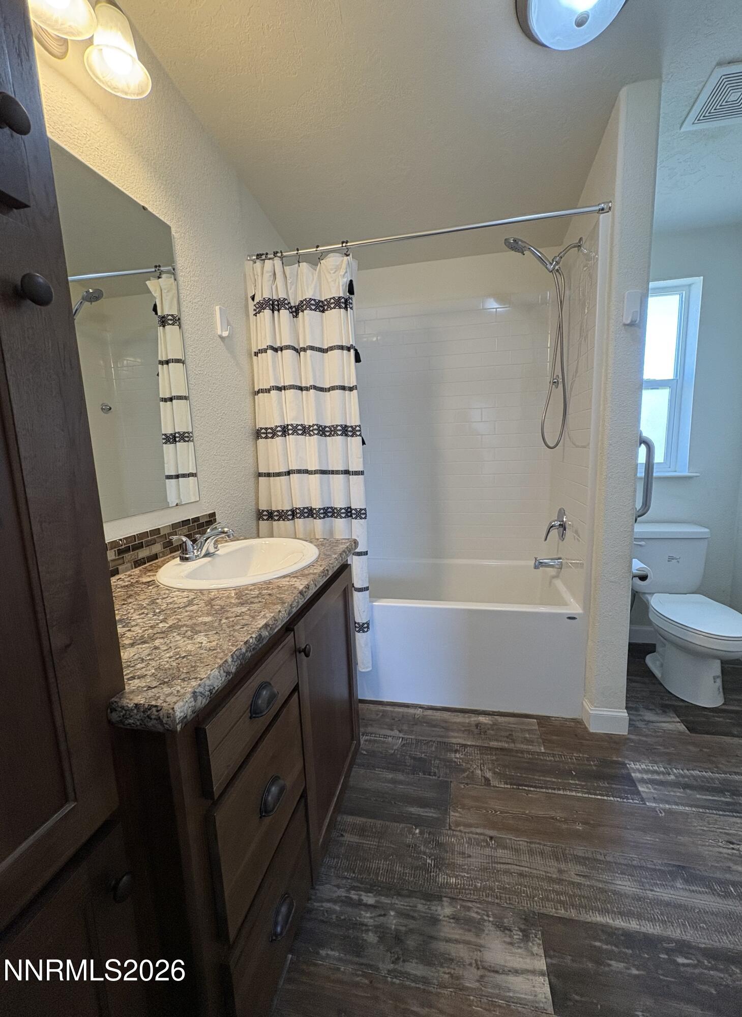 1415 Van Diest Road Winnemucca, NV 89445 - Photo 24 of 34 a bathroom with a granite countertop sink and a mirror