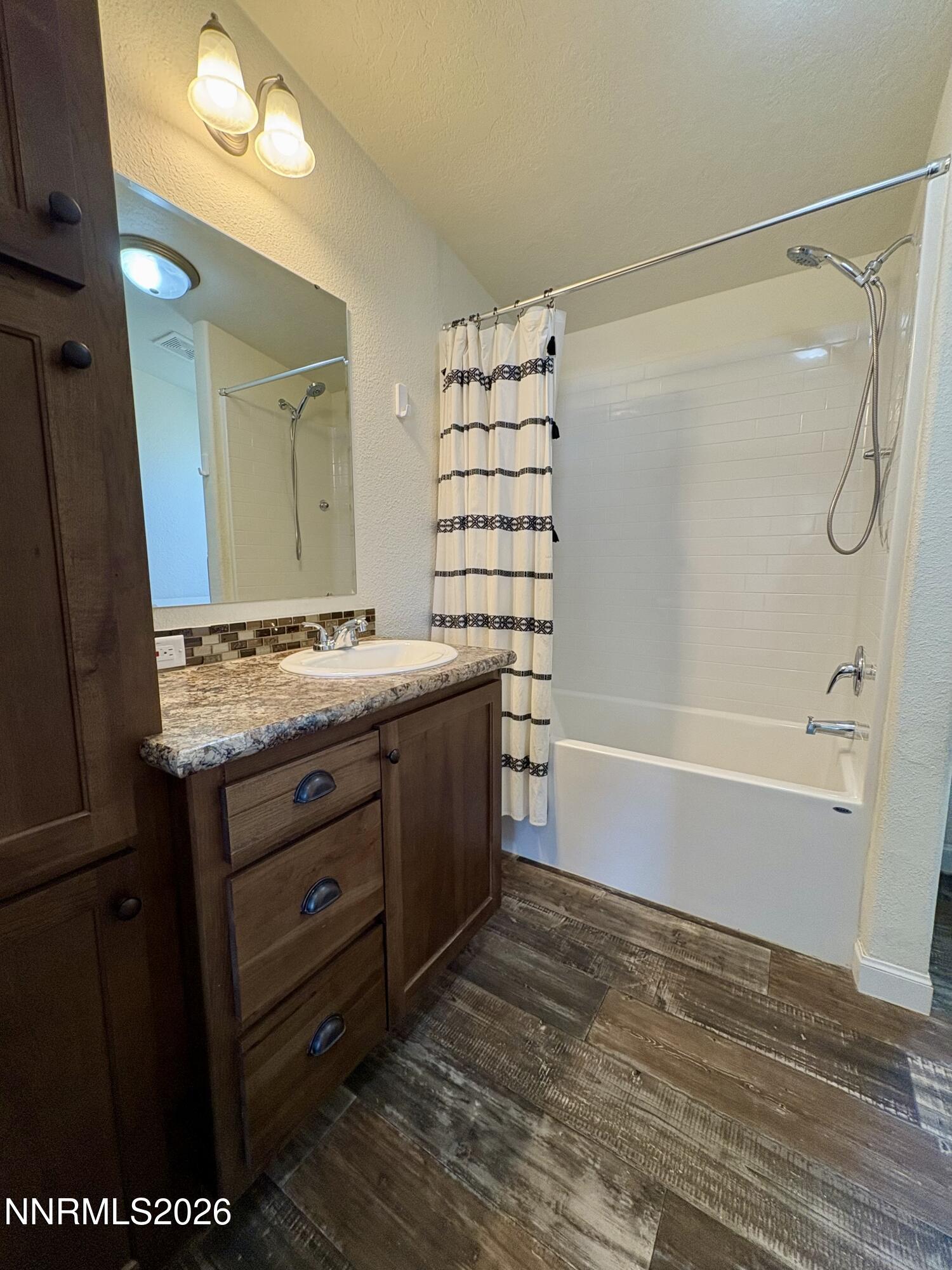 1415 Van Diest Road Winnemucca, NV 89445 - Photo 25 of 34 a bathroom with a granite countertop sink a toilet and shower