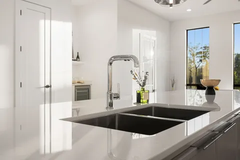 a kitchen with a sink and a refrigerator