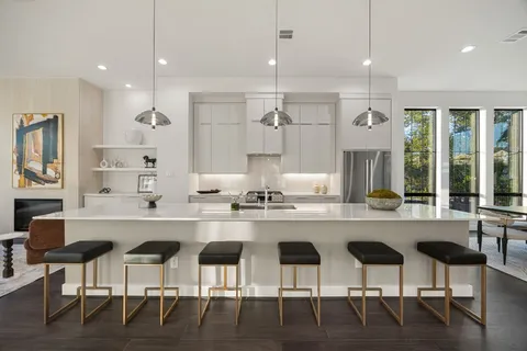 a large kitchen with a table and chairs