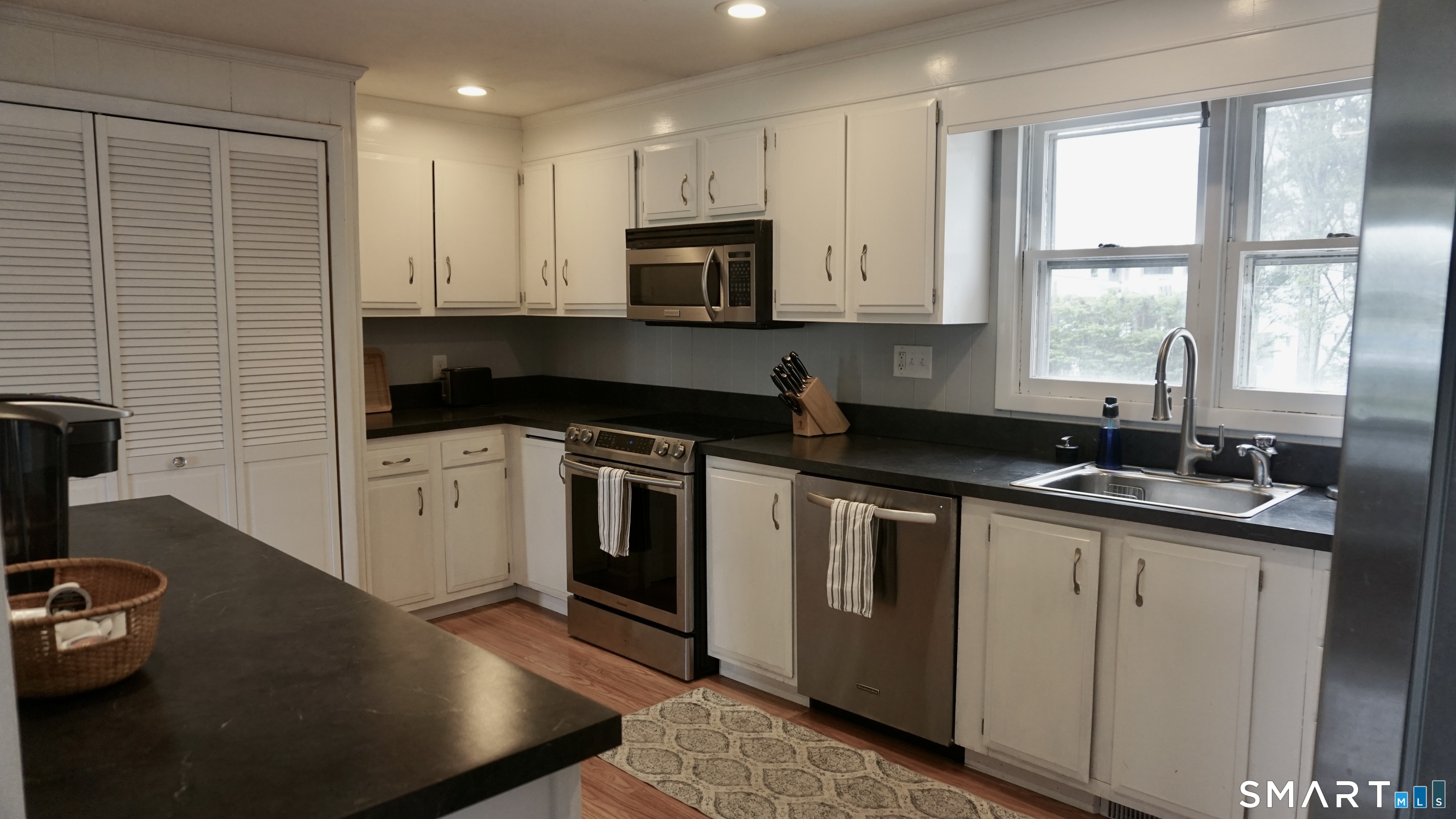 13 Pacific Street Groton, CT 06340 - Photo 4 of 31 a kitchen with a sink stove and microwave