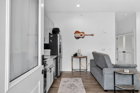 a living room with furniture and a wooden floor