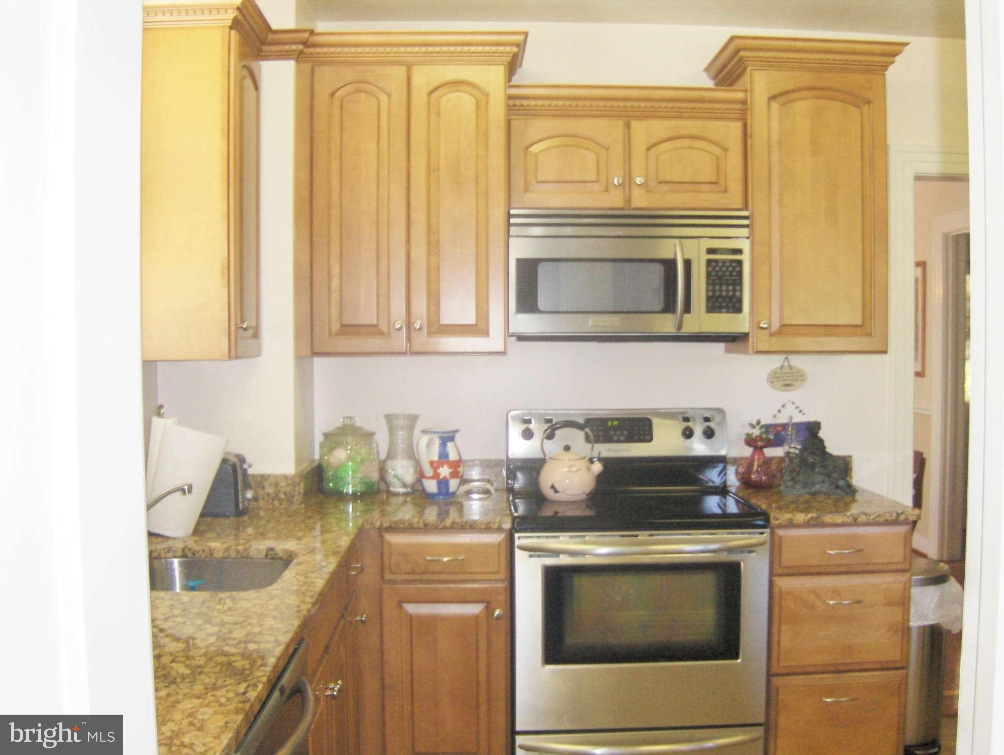 4957 Muddy Creek Road West River, MD 20778 - Photo 7 of 29 a kitchen with stainless steel appliances granite countertop a stove and a microwave