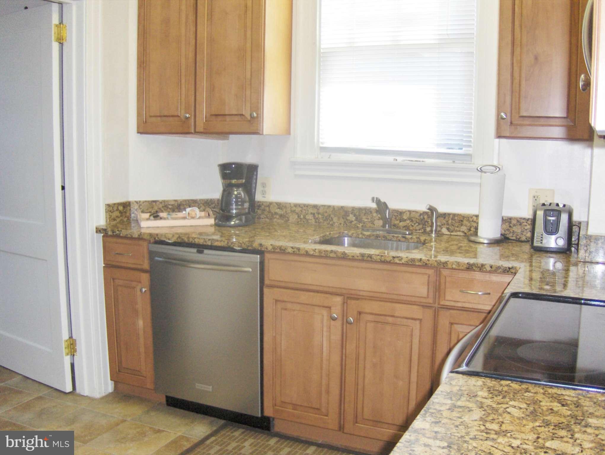 4957 Muddy Creek Road West River, MD 20778 - Photo 9 of 29 a kitchen with stainless steel appliances granite countertop a sink stove and cabinets