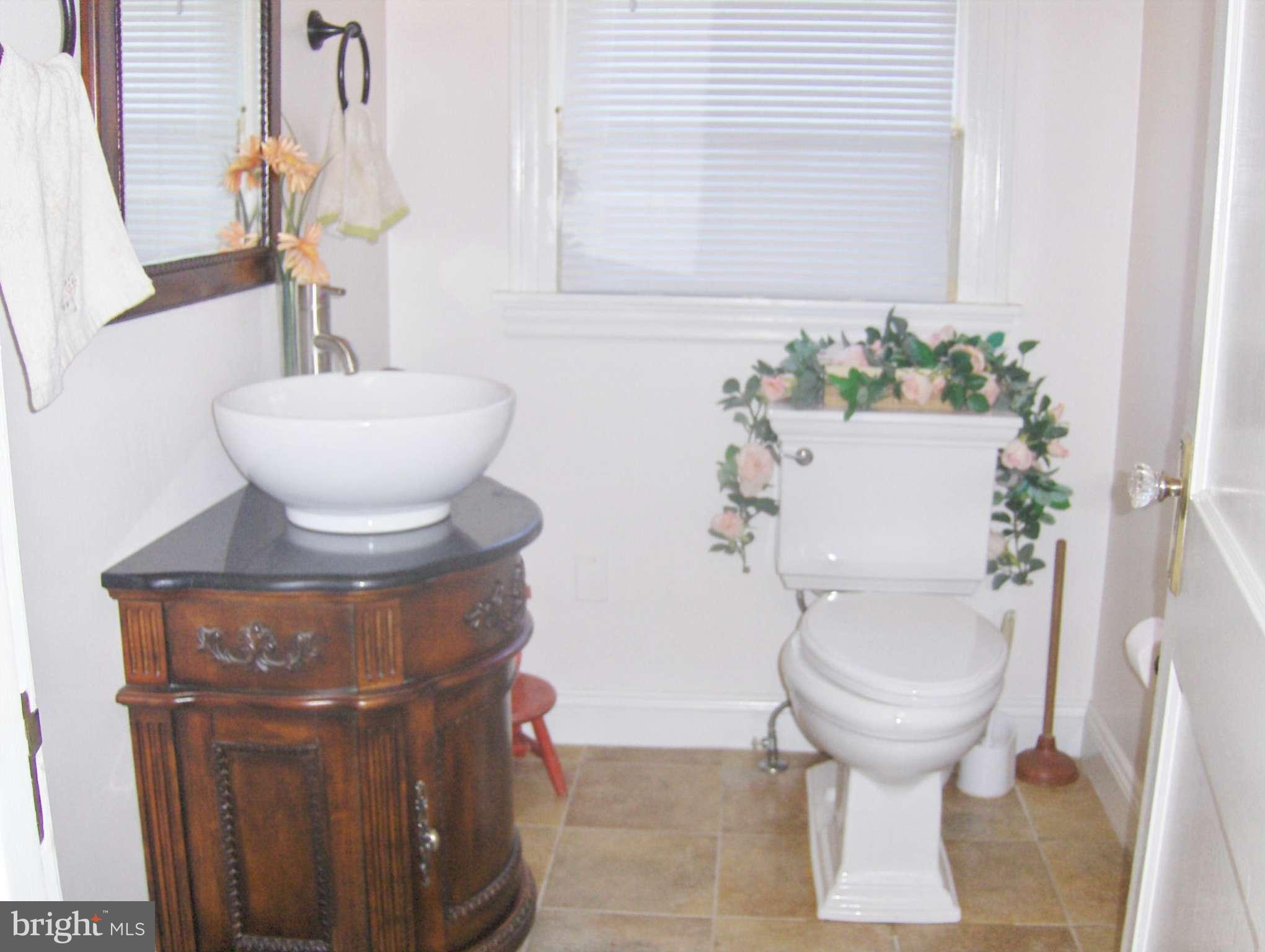 4957 Muddy Creek Road West River, MD 20778 - Photo 10 of 29 a bathroom with a toilet and a sink