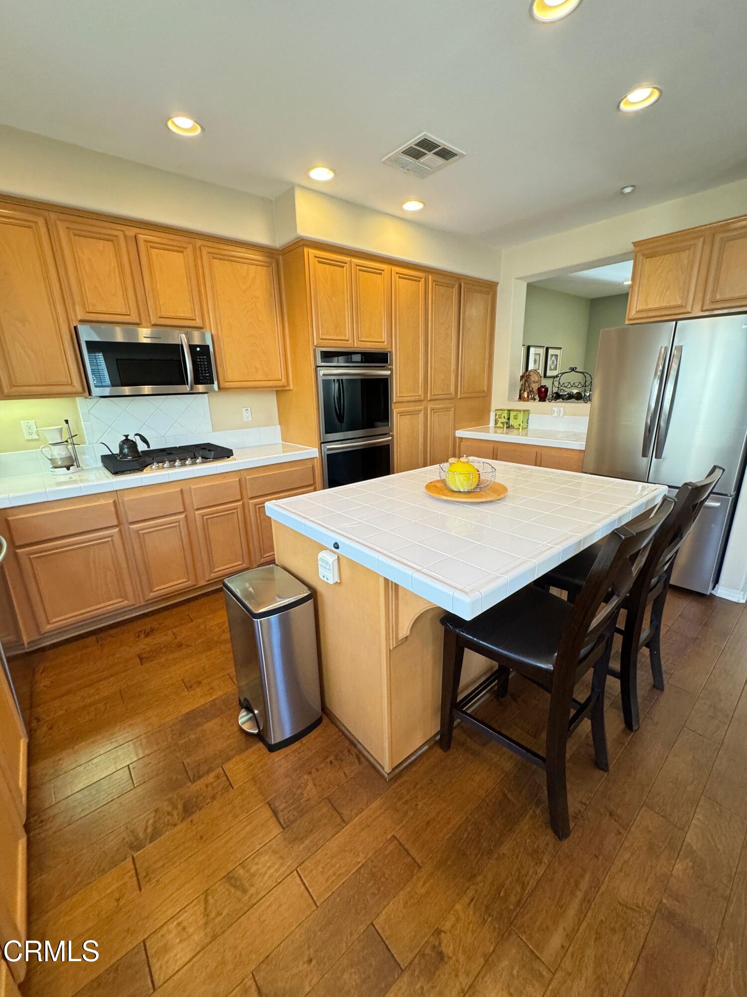 1240 Bayside Lane Oxnard, CA 93035 - Photo 28 of 69 a large kitchen with a table and chairs