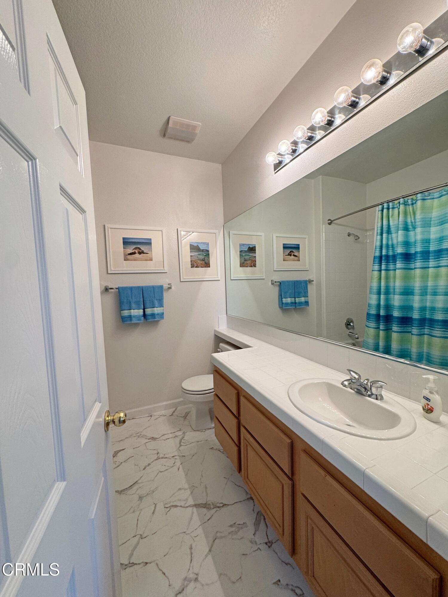 1240 Bayside Lane Oxnard, CA 93035 - Photo 38 of 69 a spacious bathroom with a sink double vanity granite and a mirror