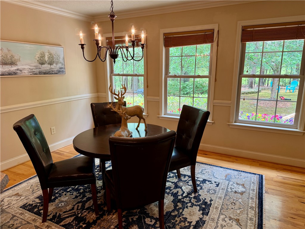 232 Hunters Trail Walhalla, SC 29691 - Photo 12 of 38 This inviting dining area features elegant crown molding and ample natural light, perfect for intimate gatherings.