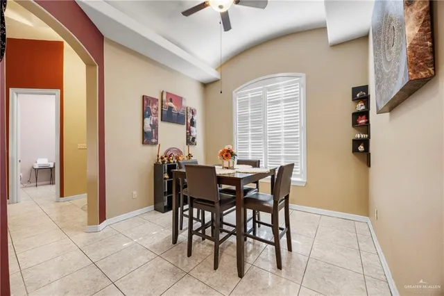 a view of a dining room with furniture and a chandelier fan