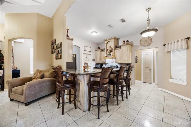 a view of a dining room with furniture and chandelier