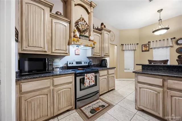 a kitchen with stainless steel appliances granite countertop a stove and a sink