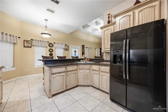 a kitchen with stainless steel appliances granite countertop a refrigerator and a sink