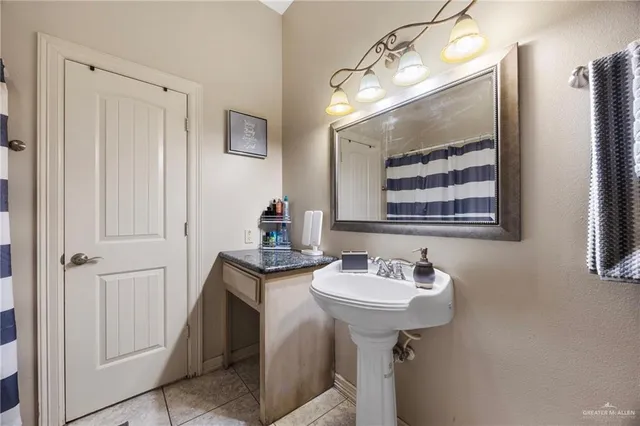 a bathroom with a sink a mirror and shower